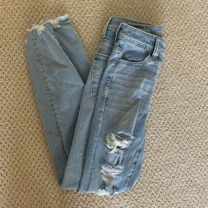 skinny high rise medium wash jeans with distress!